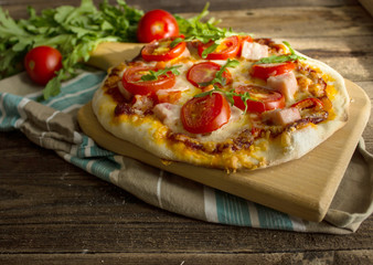 Homemade pizza on a wooden board