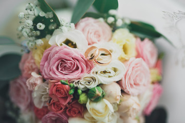 Pretty good wedding bouquet of various flowers with rings