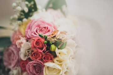 Pretty good wedding bouquet of various flowers with rings
