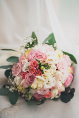Pretty good wedding bouquet of various flowers with rings