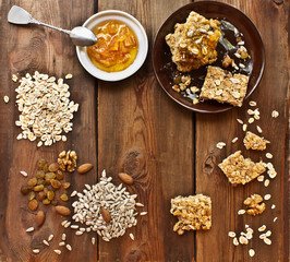 Homemade granola bars with ingredients and orange jam