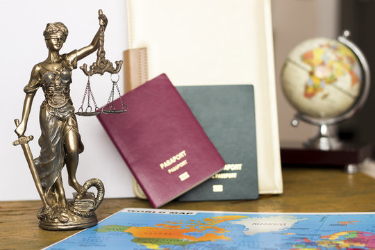 Law concept, statue, magnifying glass, passport and world map. Travel