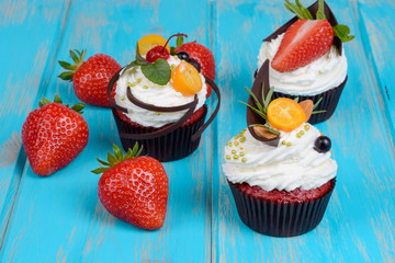 Tasty cake with pieces of fruit and strawberry on a table