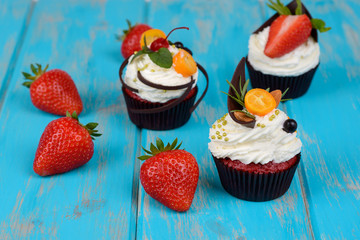 Tasty cake with pieces of fruit and strawberry on a table