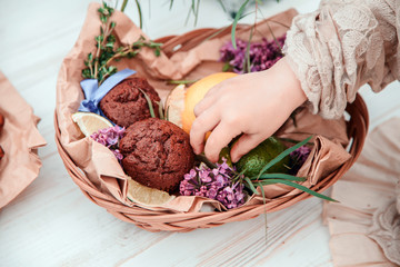 Little baby girl eats chocolate cake in nature at a picnic. The concept of a happy childhood