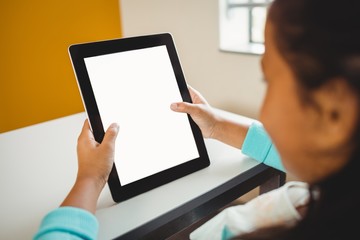 Rear view of girl using a tablet