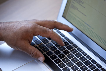 Hand on a computer