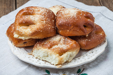 Buns with berries on a wooden table.