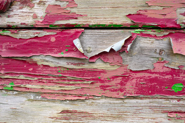 Old red paint layer on textured wooden planks