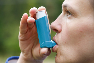 Asthma patient inhaling medication - obrazy, fototapety, plakaty