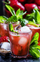 Alcoholic cocktail strawberry mojito with white rum, syrup, soda