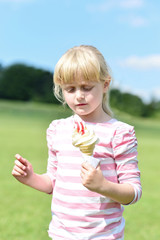 Cute little girl eating ice cream