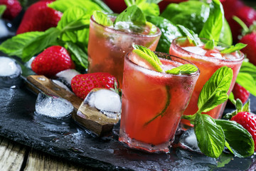 Alcoholic cocktail strawberry mojito with white rum, syrup, soda