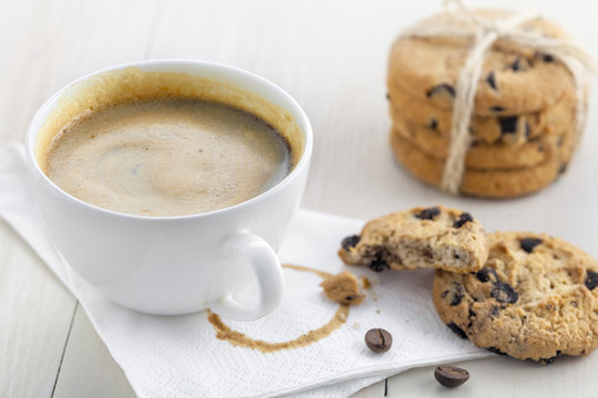 Coffee break with chip cookies. Cup of coffee with sweet biscuits and chocolate for dessert.