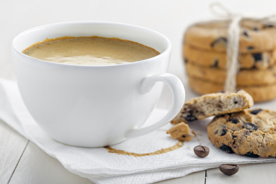 Cup of coffee with cookies on table for breakfast. Coffee break with chocolate biscuits