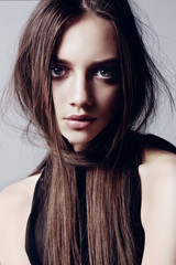 Beautiful young woman with long healthy brown hair and perfect skin