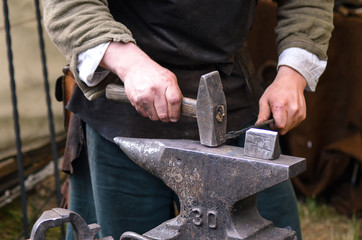 Blacksmith working on metal medieval