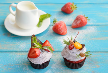Tasty cake with pieces of fruit and strawberry on a table