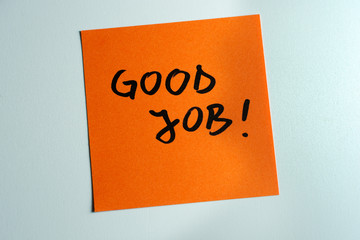 Good job written on a orange paper note