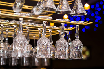 Glasses for alcoholic drinks hang above the bar