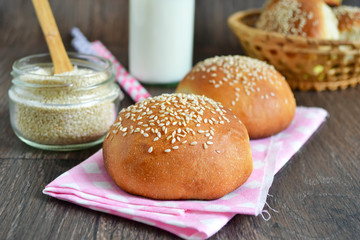 homemade buns with sesame seeds and milk for breakfast