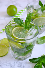 summer drink, mojito cocktail with mint and lime on a marble bac