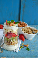 Oatmeal with yogurt, kiwi, banana, strawberries and almonds in a