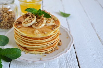 Pancake with banana, covered with honey or maple syrup with copy