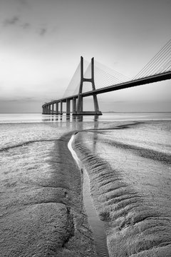 Fototapeta Vasco da Gama bridge at black and white, sunrise Lisbon