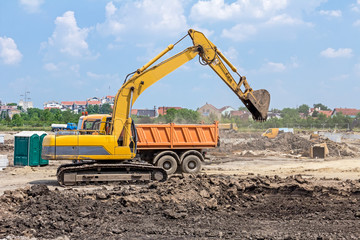 Obraz premium Excavator is working on construction site. Caterpillar in action
