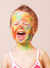 Happy cute little girl with colorful painted hands