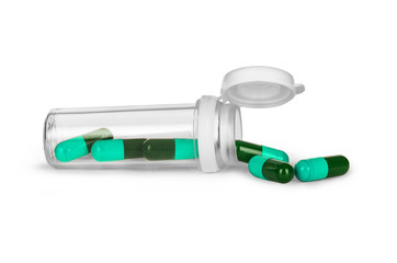 Pills spilling out of pill bottle isolated on white