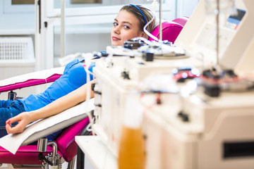 Young woman giving blood in a modern hospital