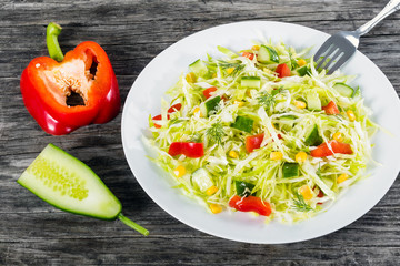 spring cabbige salad with bell pepper, corn, cucumber