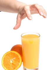 Human hand gesturing with fresh orange and full glass of orange juice taken on white background