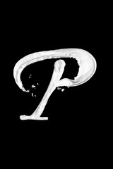Letter P made of milk, isolated on black