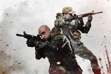 Two Special forces soldiers men take aim on machine gun