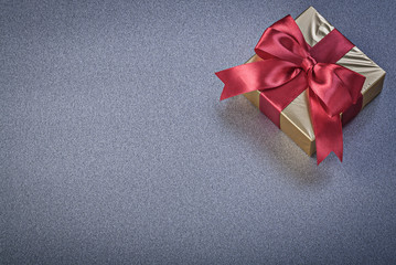 Wrapped present box on grey background holidays concept