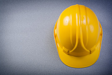 Fototapeta premium Yellow safety building helmet on grey background construction co
