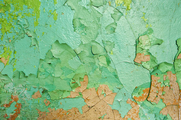 texture of the peeling green paint on a concrete wall