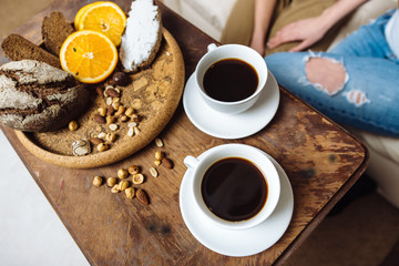 Two white cups with espresso on wood table