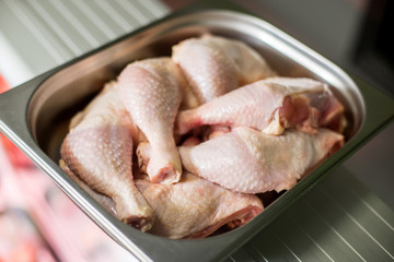 Raw chicken thighs on the iron tray