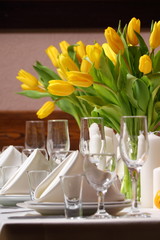 Decoration of the holiday table yellow tulips./Decoration of the holiday table yellow tulips.
