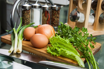 Eggs onions and herbs on a kitchen table