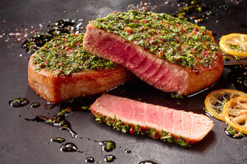 Seared Tuna Steaks Topped with Fresh Pesto - obrazy, fototapety, plakaty