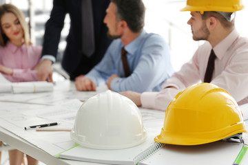 Helmets and blueprints on the office table