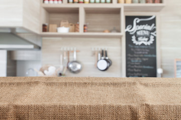 burlap on wood table top with blur kitchen background - 110816597