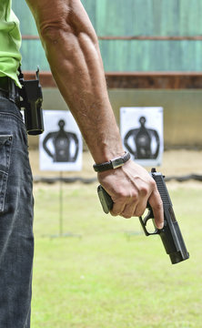 Man holding a gun ready to shoot