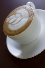 Cup of art latte or cappuccino coffee.