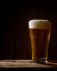 Cool beer on wood background.